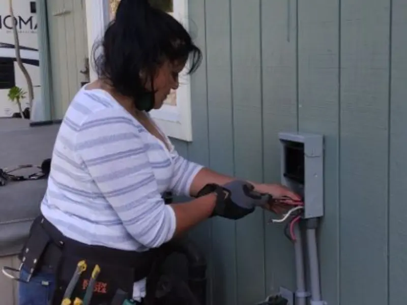 Licensed electrician wiring an exterior subpanel in Merrimac